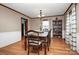 Bright dining room with hardwood floors, a wood table, and neutral decor at 6520 Weldon Nw Cir, Concord, NC 28027