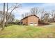 Back exterior showcasing a large backyard and garage at 6520 Weldon Nw Cir, Concord, NC 28027