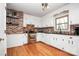 Kitchen with exposed brick, white cabinets, and granite counters at 6520 Weldon Nw Cir, Concord, NC 28027
