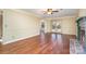 Spacious living room featuring hardwood floors, fireplace, and French doors at 6601 Porterfield Rd, Charlotte, NC 28226