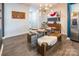 Bright dining area featuring glass table, wooden bench, and modern light fixture at 7025 Old Evergreen Pkwy, Indian Trail, NC 28079