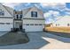 Two-story townhome with white siding, two-car garage, and landscaping at 7025 Old Evergreen Pkwy, Indian Trail, NC 28079