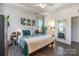 Main bedroom with large bed, ensuite bathroom access, and a full-length mirror at 7025 Old Evergreen Pkwy, Indian Trail, NC 28079