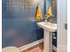 Small powder room with pedestal sink and blue walls at 7025 Old Evergreen Pkwy, Indian Trail, NC 28079