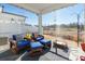 Relaxing screened porch with wooden chairs and ottomans at 7025 Old Evergreen Pkwy, Indian Trail, NC 28079