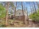 Exterior shot of a well-maintained backyard with a brick house, wooden deck and green lawn at 7401 Kilcullen Dr, Charlotte, NC 28270