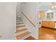 Wooden staircase with white risers leading to the upper level of the home at 7401 Kilcullen Dr, Charlotte, NC 28270