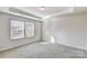 Bright bedroom with neutral walls and carpet flooring and two windows at 8020 Downy Oak Ln, Charlotte, NC 28269