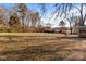 Spacious backyard with mature trees, mostly grass with leaf coverage at 809 S Bostian St, China Grove, NC 28023