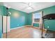 Bedroom with teal walls, wood floors and a treadmill at 927 Ferguson Ridge Rd, Gastonia, NC 28052