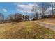 Brick ranch house with a long gravel driveway and mature trees at 927 Ferguson Ridge Rd, Gastonia, NC 28052