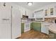 Galley kitchen with white cabinets, stone backsplash, and green countertops at 927 Ferguson Ridge Rd, Gastonia, NC 28052