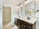 Double vanity bathroom with dark cabinets and a walk-in shower at 1000 Lily Pond Cir, Waxhaw, NC 28173