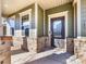 Inviting front door with glass panes and brick porch at 1000 Lily Pond Cir, Waxhaw, NC 28173