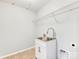 Bright laundry room with a utility sink and ample shelving at 1000 Lily Pond Cir, Waxhaw, NC 28173