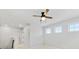 Loft with neutral walls, ceiling fan, and multiple windows at 1000 Lily Pond Cir, Waxhaw, NC 28173