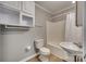 Clean bathroom with tub, sink, and overhead storage at 105 Linden St, Clover, SC 29710