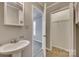 Simple bathroom with pedestal sink and linen closet at 105 Linden St, Clover, SC 29710