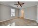 Cozy bedroom with ceiling fan, large window, and wood-look floors at 105 Linden St, Clover, SC 29710