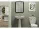 Convenient bathroom with pedestal sink and toilet at 1078 Old Trade St, Edgemoor, SC 29712