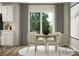 Dining area with round table and four beige chairs, near sliding door at 1078 Old Trade St, Edgemoor, SC 29712