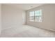 Bedroom featuring neutral walls, carpet flooring, and a view to the back of the property at 1187 Blackburn Cir, Edgemoor, SC 29712