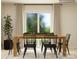 Dining room with wooden table and black chairs, sliding glass doors at 1187 Blackburn Cir, Edgemoor, SC 29712