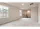 Upstairs loft area with multiple windows and neutral color scheme at 1187 Blackburn Cir, Edgemoor, SC 29712