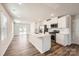 Open-concept kitchen featuring white cabinets, a stainless steel microwave, and an eat-in island with a sink at 1189 Blackburn Cir, Edgemoor, SC 29712