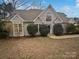 Two-story house with beige siding, a large window, and landscaping at 12064 Spinnaker Dr, Fort Mill, SC 29708