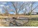 Spacious backyard featuring mature trees and a brick fire pit, perfect for outdoor entertaining at 1209 Austin Chaney Rd, Wingate, NC 28174