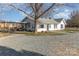 Exterior view of home with gravel driveway and covered parking at 1209 Austin Chaney Rd, Wingate, NC 28174