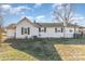 Rear view of this single story house with white siding, black shutters and a well maintained lawn at 1209 Austin Chaney Rd, Wingate, NC 28174