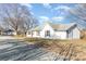 Charming single-story home boasts a classic white exterior, complemented by black shutters and a well-maintained lawn at 1209 Austin Chaney Rd, Wingate, NC 28174