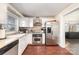 This cozy kitchen features stainless steel appliances, wooden floors, and ample counter space at 1209 Austin Chaney Rd, Wingate, NC 28174