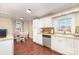 Bright kitchen featuring white cabinets and updated appliances, with a view to the dining area at 1209 Austin Chaney Rd, Wingate, NC 28174