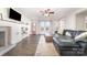 Bright living room with a modern fireplace, television, ceiling fan, and hardwood flooring at 1209 Austin Chaney Rd, Wingate, NC 28174