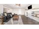 Comfortable living room featuring a modern fireplace, ceiling fan, and hardwood flooring at 1209 Austin Chaney Rd, Wingate, NC 28174