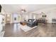 Bright and spacious living room featuring modern ceiling fan, dark wood floors, and fireplace at 1209 Austin Chaney Rd, Wingate, NC 28174