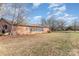 Rustic outbuilding with a weathered red exterior, and a partially caved in roof surrounded by a large lot at 1209 Austin Chaney Rd, Wingate, NC 28174