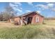 Rustic outbuilding with a weathered red exterior, showing lots of natural light from multiple windows at 1209 Austin Chaney Rd, Wingate, NC 28174