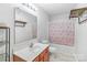 Bathroom with sink vanity and tub/shower combo with bright light fixture and open shelving at 1219 Century Dr, Clover, SC 29710