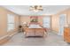 Bright bedroom with wood-framed bed, ceiling fan, and neutral decor at 1219 Century Dr, Clover, SC 29710