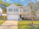 Two-story house with beige siding, a white garage door, and a landscaped lawn at 1219 Century Dr, Clover, SC 29710