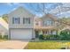 Two-story house with beige siding, a gray door, and manicured landscaping at 1219 Century Dr, Clover, SC 29710