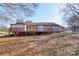 Exterior view of the home and wooden deck in the backyard of the home on a sunny day at 1304 Cambridge Dr, Shelby, NC 28152