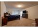 Primary bedroom featuring neutral carpet, double door closets and access to outdoor space at 1304 Cambridge Dr, Shelby, NC 28152