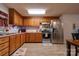 Well-lit kitchen features wood cabinets, stainless steel appliances, and updated flooring at 1304 Cambridge Dr, Shelby, NC 28152