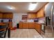 Traditional kitchen featuring wooden cabinets, laminate flooring, modern appliances, and neutral countertops at 1304 Cambridge Dr, Shelby, NC 28152