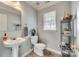 Clean and simple half bathroom with pedestal sink and tiled floor at 1309 Winding Branch Ct, Charlotte, NC 28216